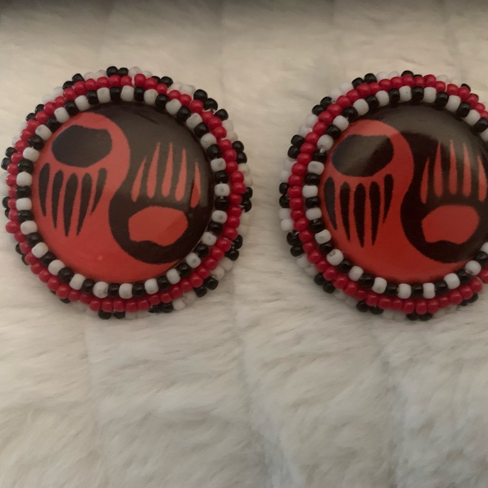 Leather and beaded around orange , black and white round earrings.bear paw A.I